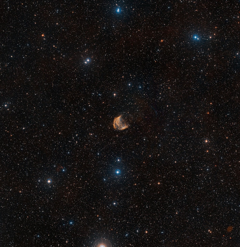 This wide-field view shows the sky around the large but faint planetary nebula known as the Medusa Nebula. The full extent of the object can be seen, as well as many faint stars and, far beyond them, numerous distant galaxies.This picture was created from images forming part of the Digitized Sky Survey 2.