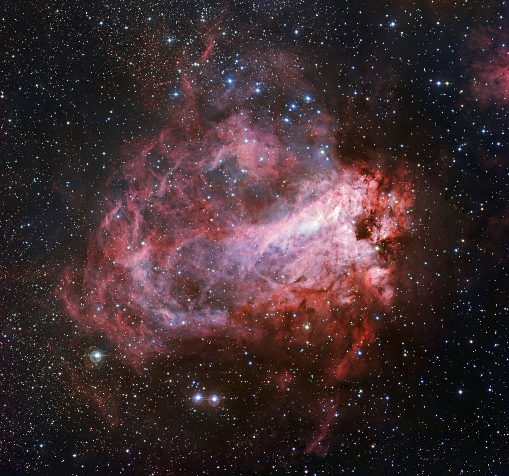 This image of the rose-coloured star forming region Messier 17 was captured by the Wide Field Imager on the MPG/ESO 2.2-metre telescope at ESO’s La Silla Observatory in Chile. It is one of the sharpest images showing the entire nebula and not only reveals its full size but also retains fine detail throughout the cosmic landscape of gas clouds, dust and newborn stars.