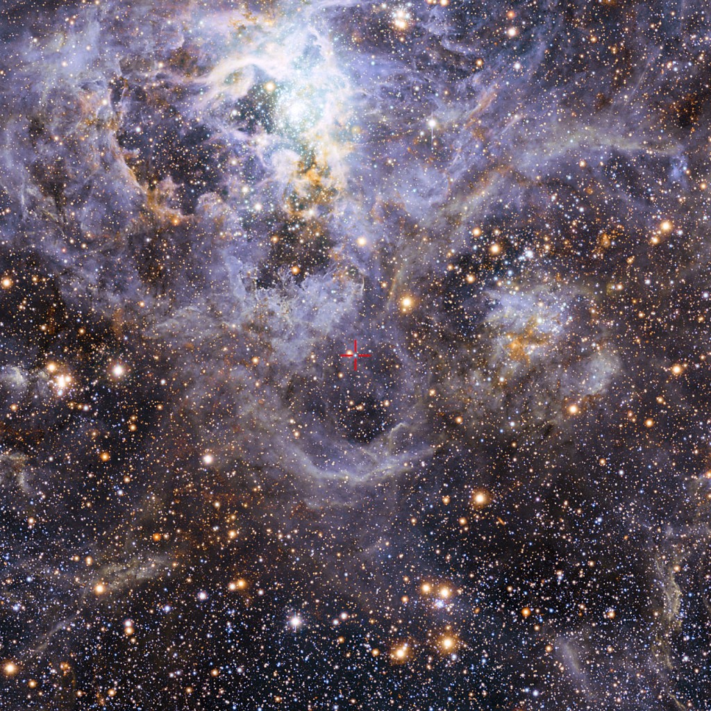 This image shows the location of VFTS 352 — the hottest and most massive double star system to date where the two components are in contact and sharing material. The two stars in this extreme system lie about 160 000 light-years from Earth in the Large Magellanic Cloud. This intriguing system could be heading for a dramatic end, either merging to form a single giant star or forming a binary black hole. This view of the Tarantula star-forming region includes visible-light images from the Wide Field Imager at the MPG/ESO 2.2-metre telescope at La Silla and infrared images from the 4.1-metre infrared VISTA telescope at Paranal.