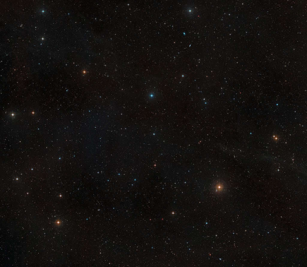 This image shows the sky around the nearby young star AU Microscopii. It was created from images forming part of the Digitized Sky Survey 2. AU Mic appears just below the centre of the image as an orangish star of moderate brightness. Because the photographs through different coloured filters that were used to make this picture were taken many years apart, AU Mic appears double, as the star’s own proper motion has moved it a small distance across the sky in the intervening time.