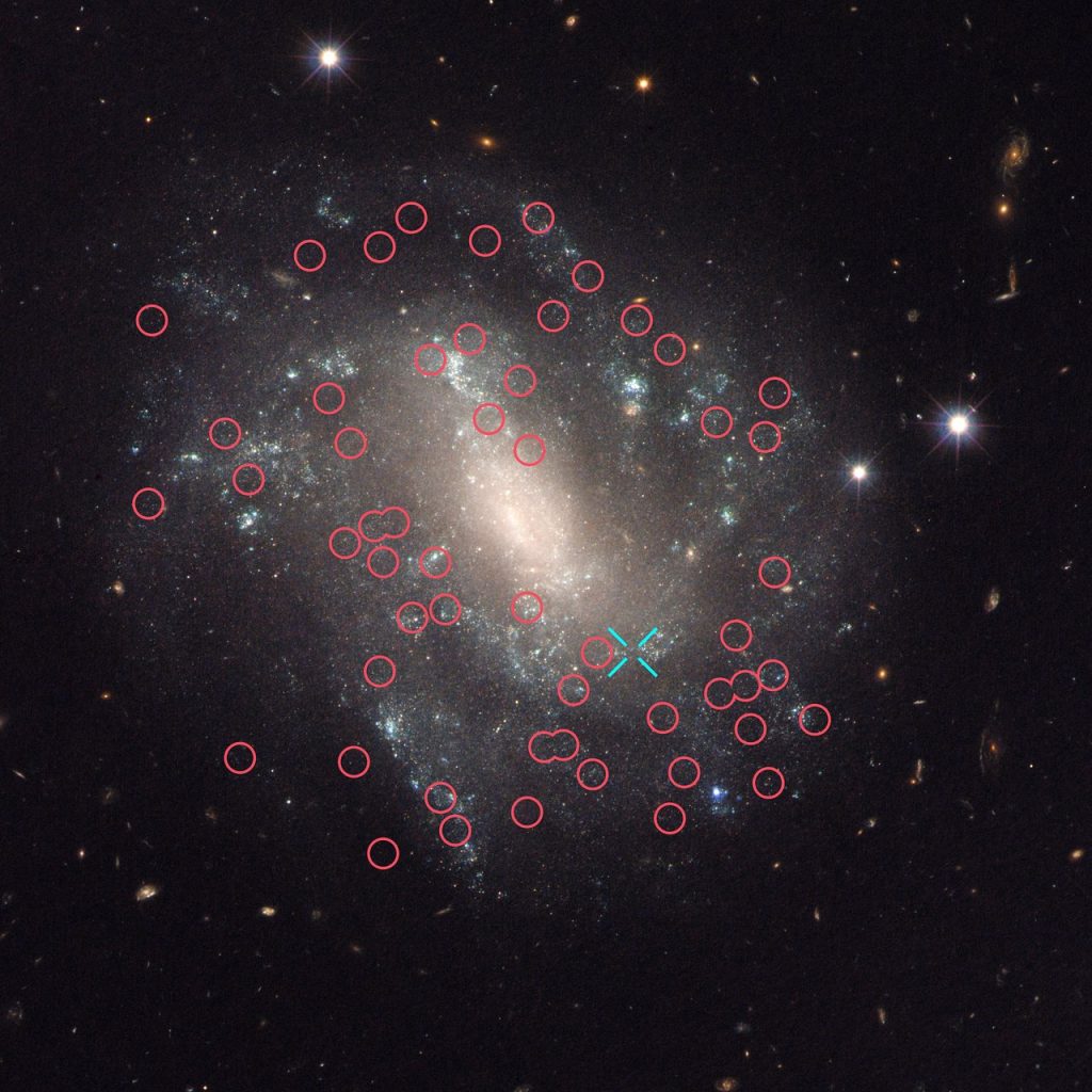   This image taken with the NASA/ESA Hubble Space Telescope shows one of the galaxies in the survey to refine the measurement for how fast the Universe expands with time, called the Hubble constant. The galaxy, UGC 9391, contains two types of stars that astronomers use to calculate accurate distances to galaxies, a key measurement in determining the Hubble constant: Cepheid variables (marked with red circles) which pulsate at rates that correspond to their true brightness; and a Type Ia supernova (the blue cross indicates the position of the supernova 2003du). These supernovae are another commonly used cosmic yardstick. They flare with the same brightness and are brilliant enough to be seen from relatively longer distances. Astronomers calibrate the supernovae with the Cepheids in galaxies such as UGC 9391 so that they can accurately calculate the distances to faraway exploding stars. UGC 9391 itself resides about 130 million light-years from Earth.