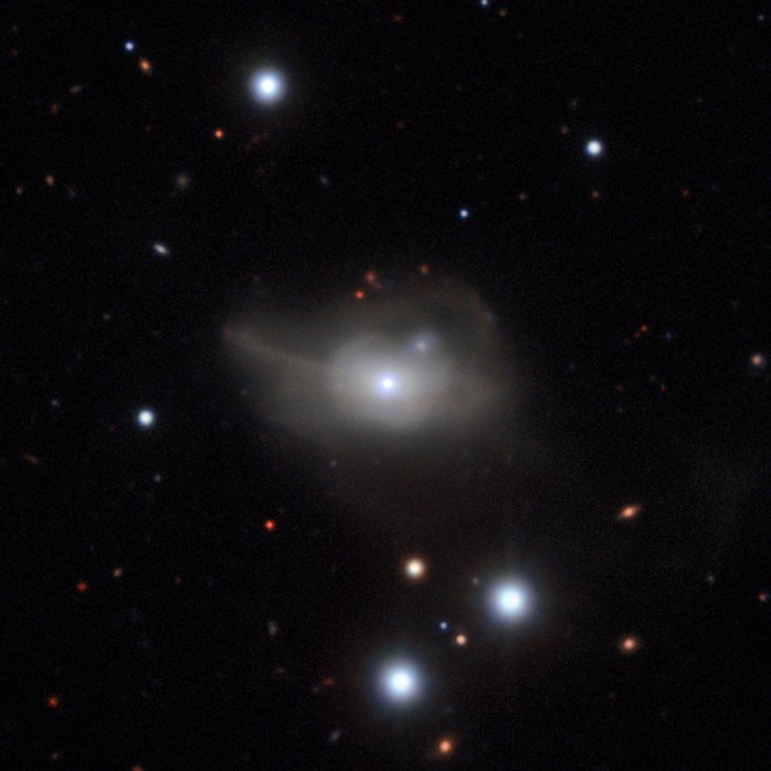 This image from the MUSE instrument on ESO’s Very Large Telescope shows the active galaxy Markarian 1018, which has a supermassive black hole at its core. The faint loops of light around the galaxy are a result of its interaction and merger with another galaxy in the recent past.