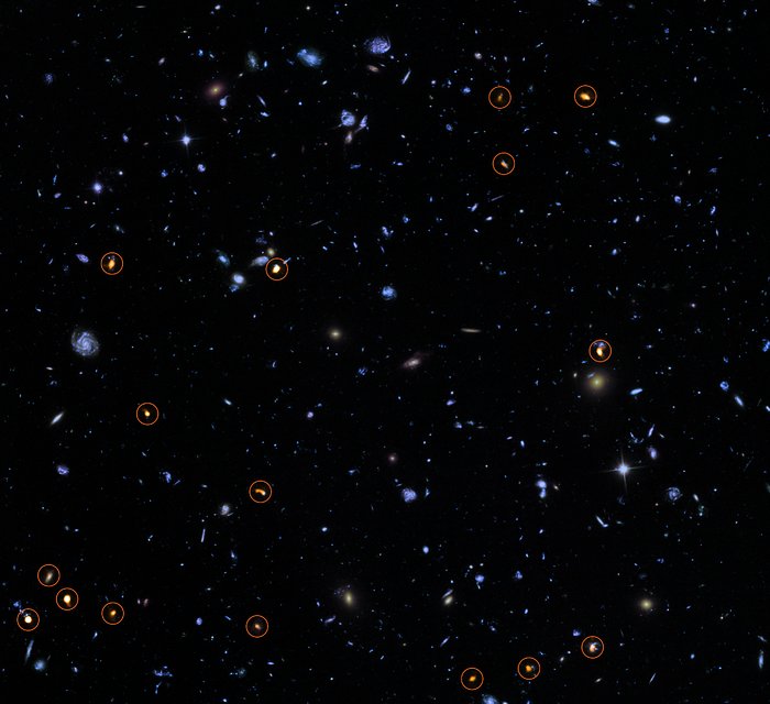 This image combines a background picture taken by the NASA/ESA Hubble Space Telescope (blue/green) with a new very deep ALMA view of this field (orange, marked with circles). All the objects that ALMA sees appear to be massive star-forming galaxies. This image is based on the ALMA survey by J. Dunlop and colleagues, covering the full HUDF area.