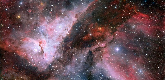 This spectacular panoramic view combines a new image of the field around the Wolf–Rayet star WR 22 in the Carina Nebula (right) with an earlier picture of the region around the unique star Eta Carinae in the heart of the nebula (left). The picture was created from images taken with the Wide Field Imager on the MPG/ESO 2.2-metre telescope at ESO’s La Silla Observatory in Chile. This image is available as a mounted image in the ESOshop. #L